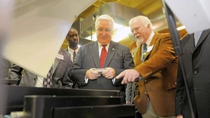 Kent Rockwell, right, chairman and CEO of ExOne, shows Gov. Tom Corbett parts manufactured by ExOne in North Huntingdon.

