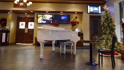 The entrance of Roman Bistro on Ardmore Boulevard features a baby grand piano.