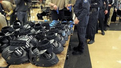 Officers get their "sim-guns" and helmets in the South Fayette cafeteria.