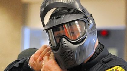 An officer makes adjustments on his helmet.